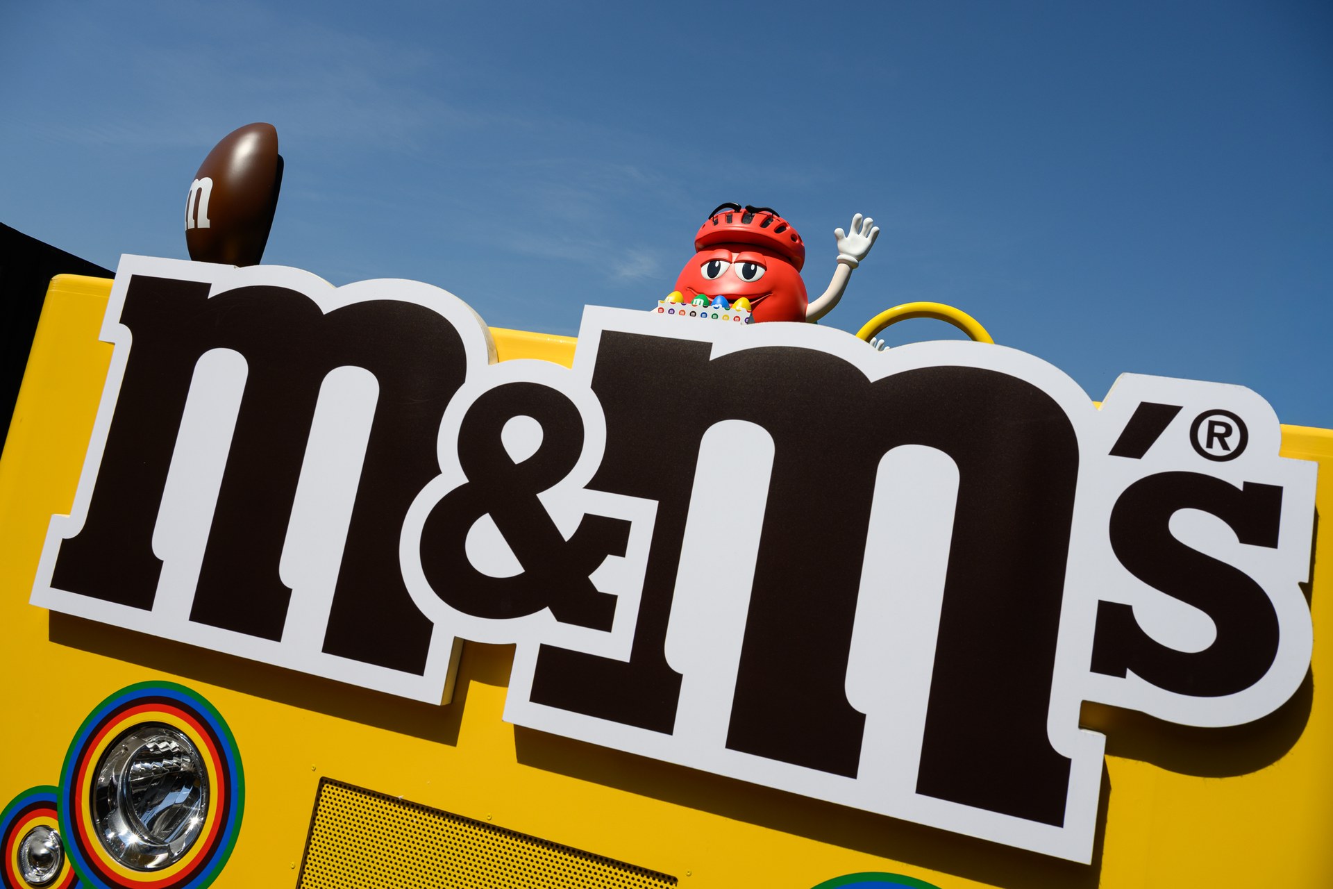 Giant M&M’S float with the Red character in a cycling helmet on the Tour de France caravan